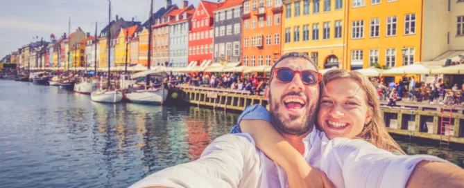 Couple takes a selfie in the Nyhavn district of Copenhagen, Denmark